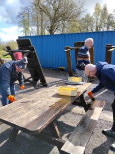 Lagan Valley & Enniskillen Rotary Club painting picnic benches at Share Discovery Village, Co Fermanagh, N Ireland
